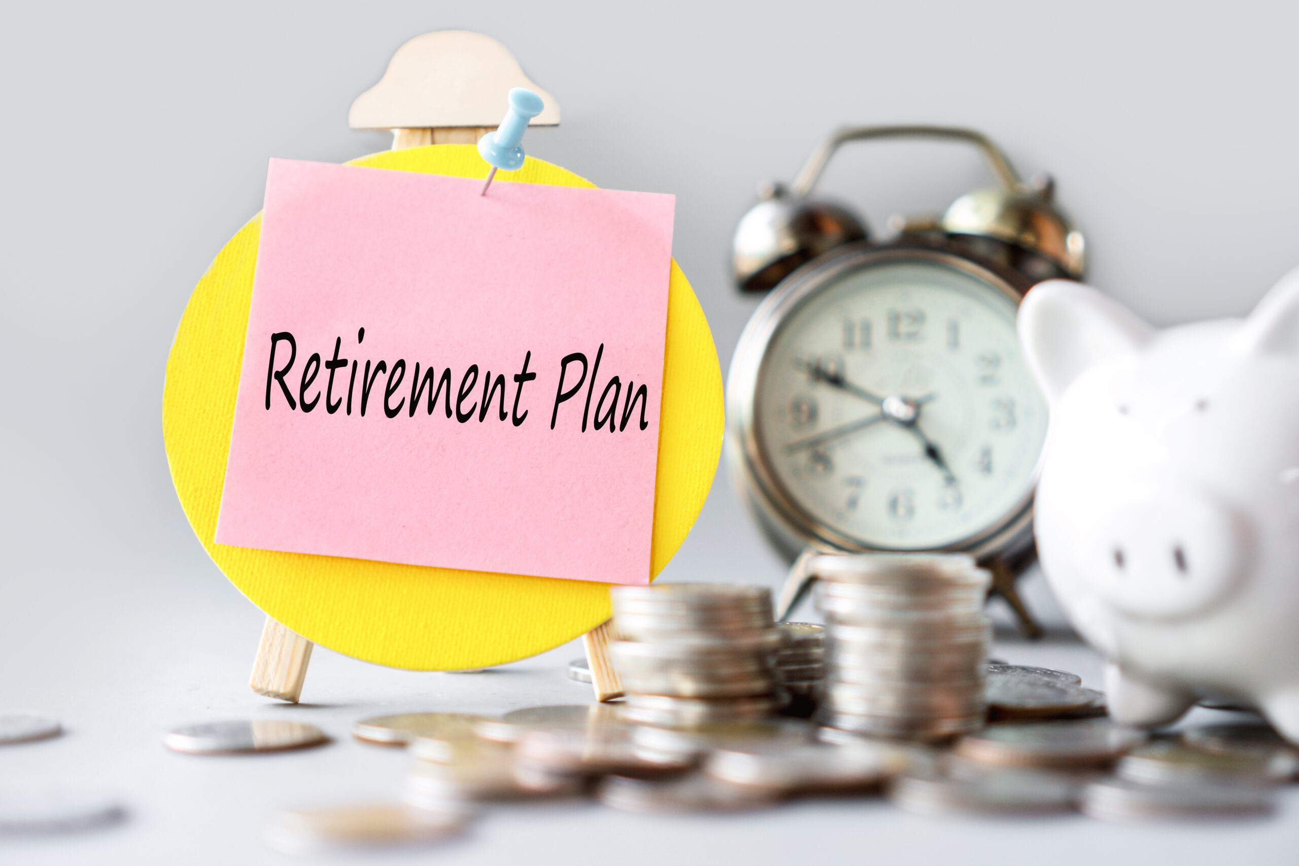retirement-plan-with-coin-clock-piggy-bank-saving-money-investment-concept