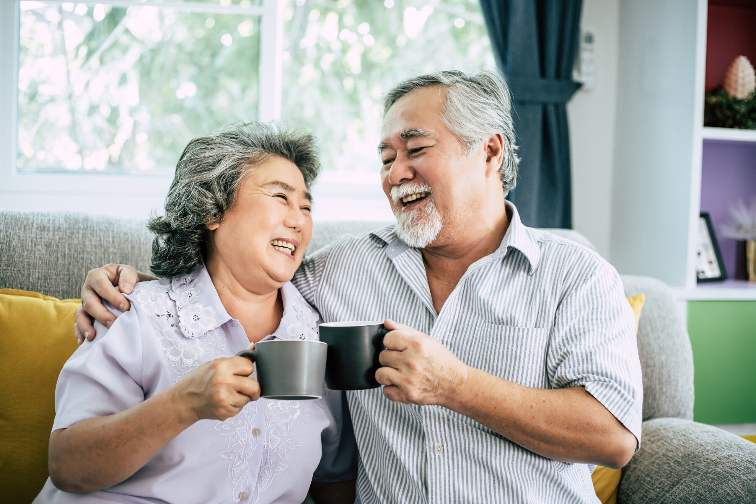 Elderly Couple Talking together and drinking coffee or milk Elderly Couple Talking together and drinking coffee or milk